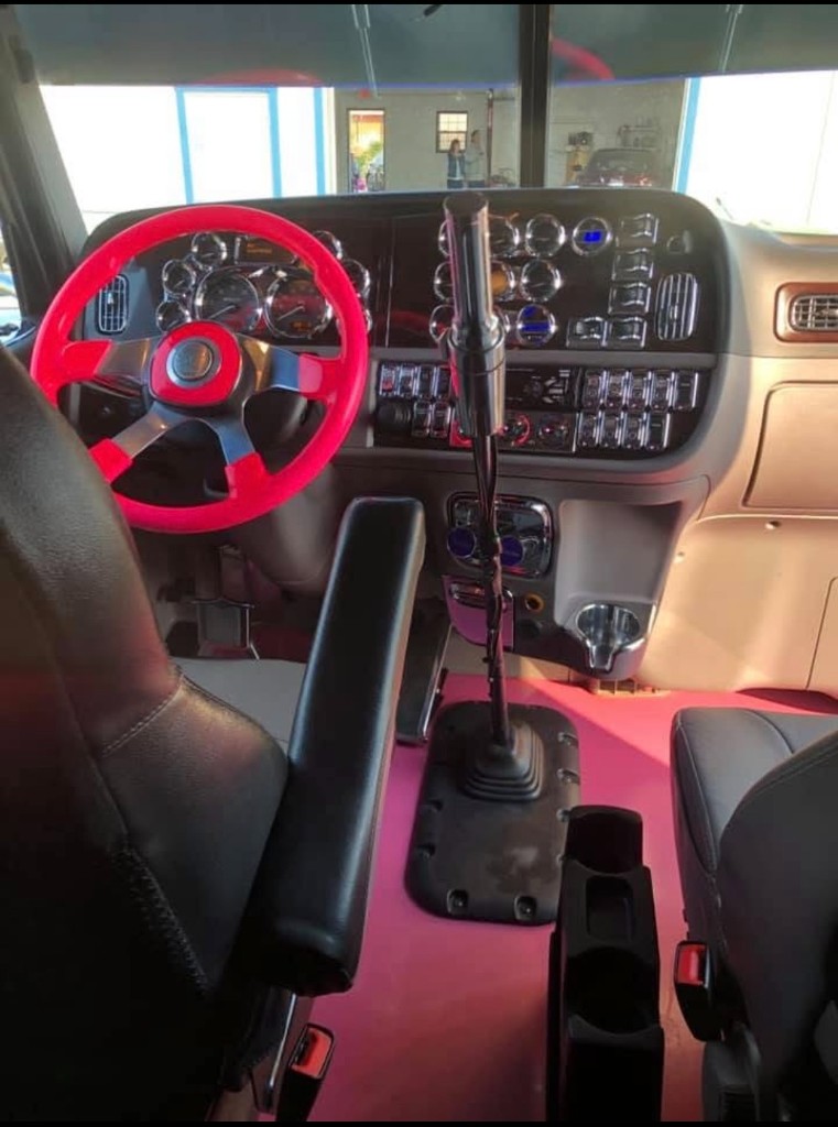 Custom truck interior detailing with red steering wheel